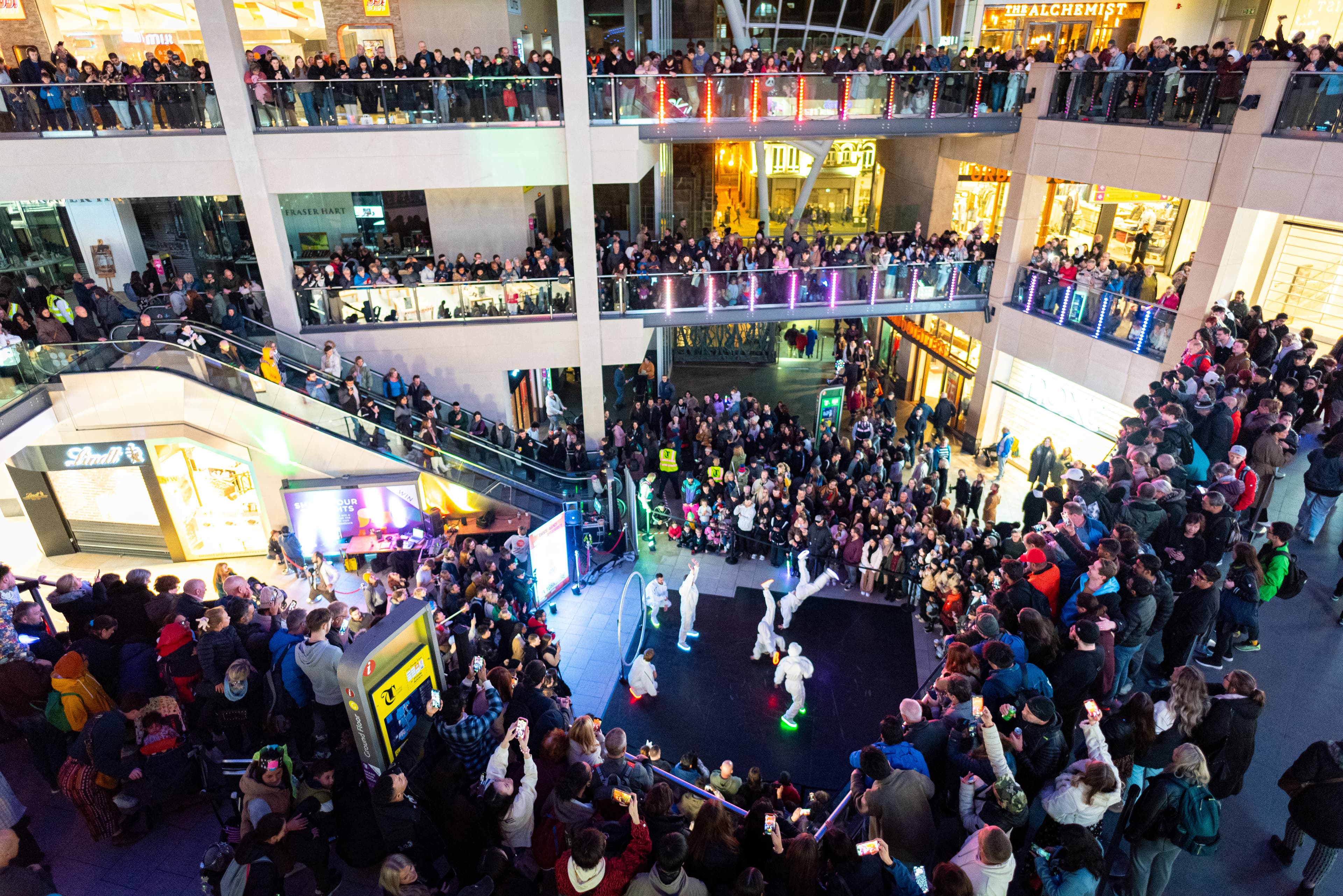 large audience on various levels watch a performance in the round