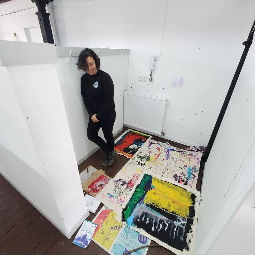 Niko working in her old studio pod, working large abstract paintings on canvas sheets.
