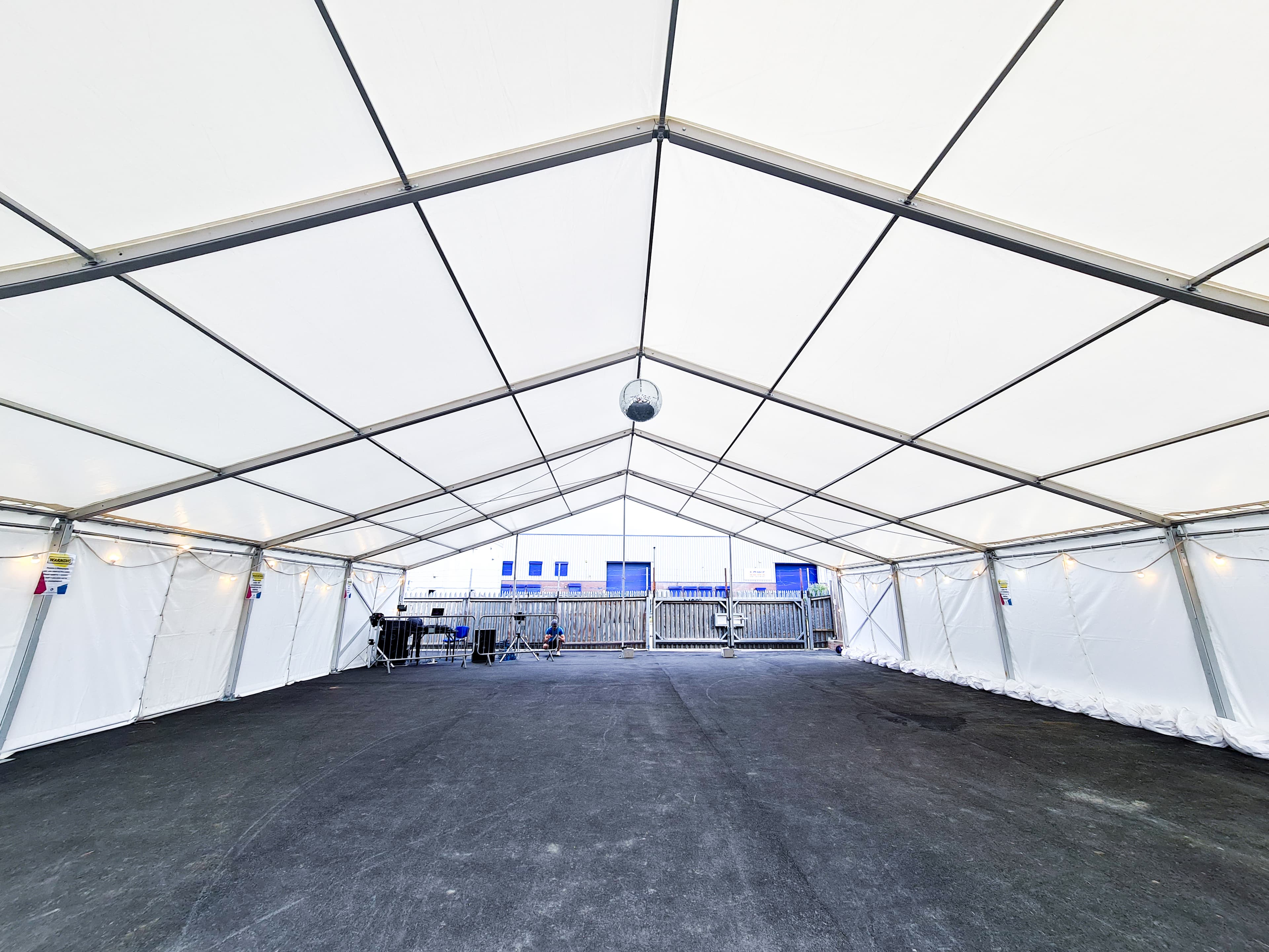 large white clearspan marquee set up with a PA and disco ball