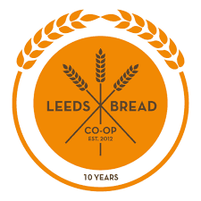 co-lab kitchen open source arts leeds logo on a bright orange background