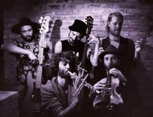 Five piece band Igneous Fig create an irreverent atmosphere, playing bass, guitar, percussion, flute and fiddle.