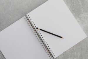 image of a blank notebook, with a pencil on it and waiting