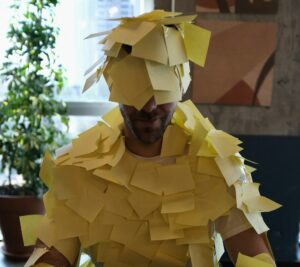 a person covered in yellow sticky post-it notes